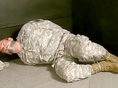 Soldier hogtied tape gagged and struggling...